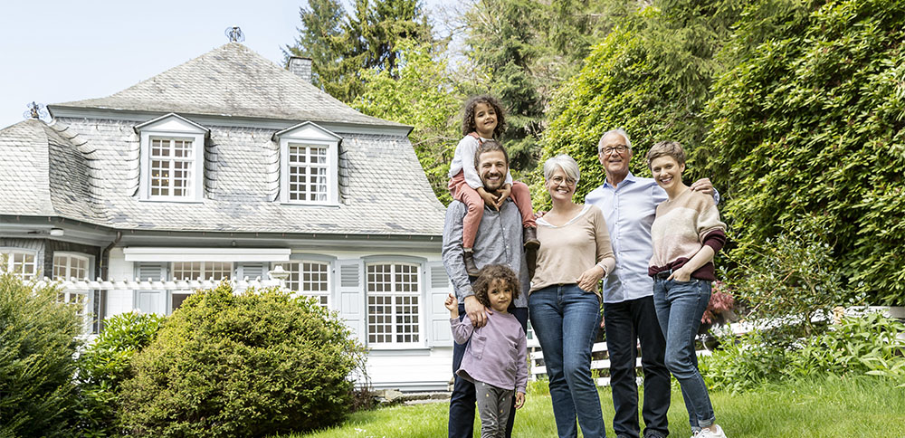 happy-extended-family-standing-in-garden-of-their-2024-09-17-20-08-59-utc