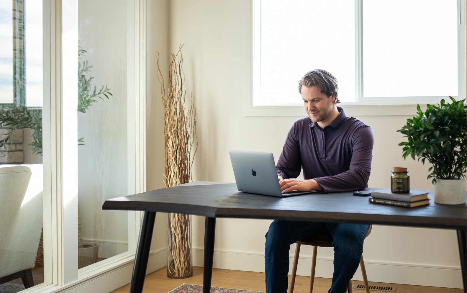 dillan kelly sitting at a desk working on a laptop